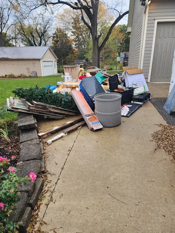 Dumpster being loaded with debris for Estate Cleanout Dumpster Rental in Petersburg
